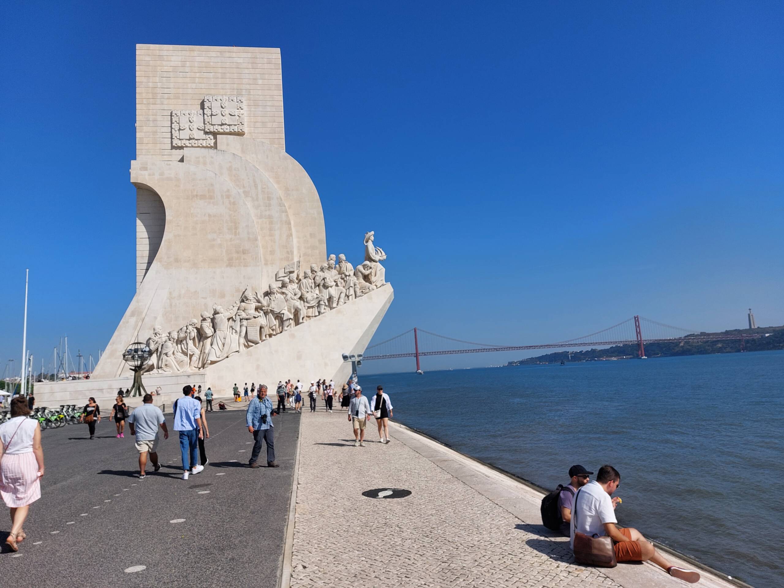 The Monument to the Discoveries on the Tagus waterfront, with the Ponte 25 de Abril visible in the distance
