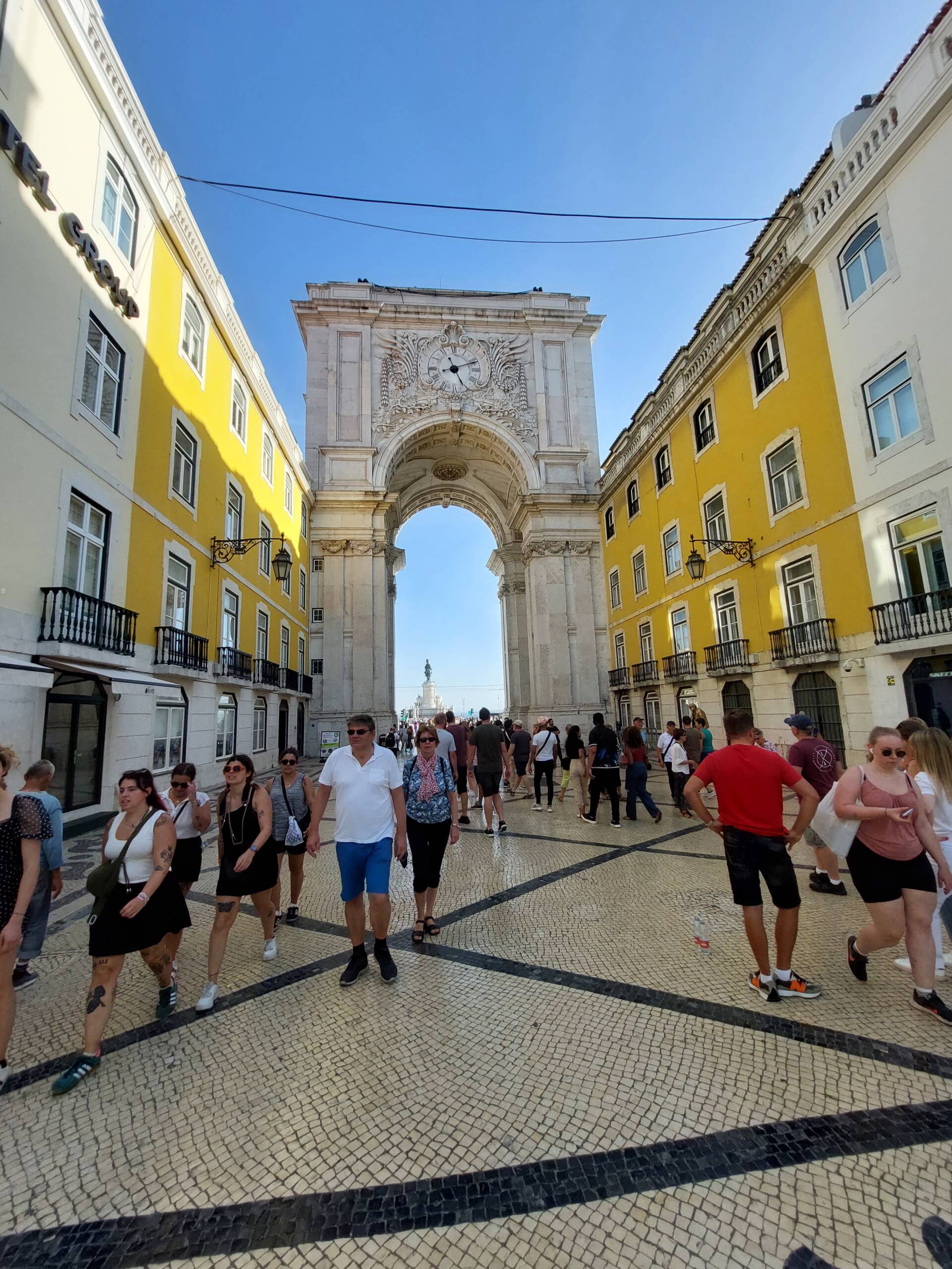 The Arco da Rua Augusta framed by yellow Pombaline facades on the Rua Augusta, Lisbon