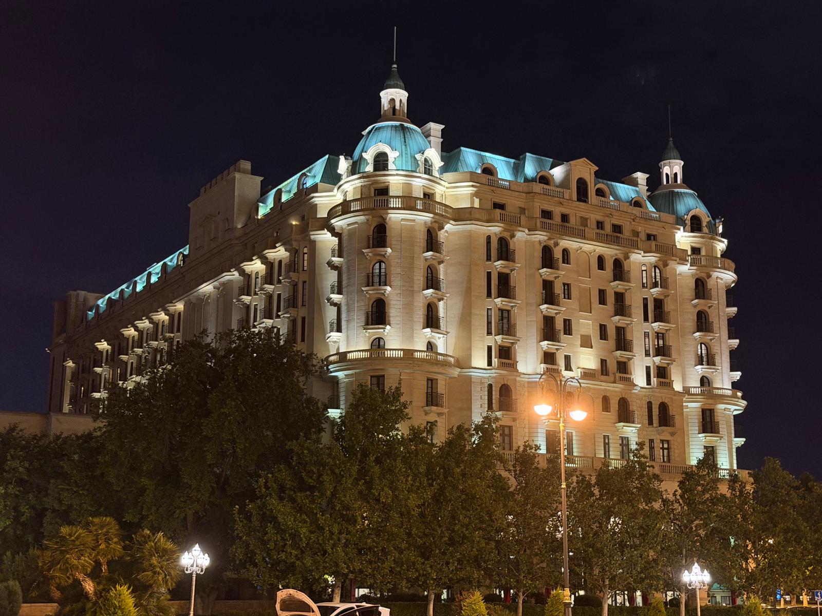 The illuminated beaux-arts Four Seasons Hotel Baku with green domes at night